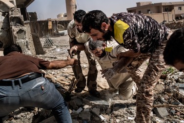 Sniper sequence #2 - Fighters loyal to Libya's Government of National Accord help a wounded comrade after he was shot by an Islamic State (IS) group sniper on the western frontline in Sirte on October 2, 2016