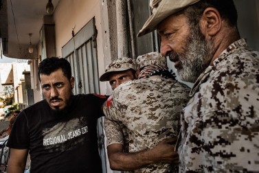 Pro-Libyan government fighters mourn the death of their comrade killed by the Islamic State (IS) in front of the field hospital in Sirte on September 22, 2016.