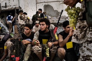 Fighters loyal to Libya's Government of National Accord, eating grapes during a break on the western frontline against IS (Islamic State) in Sirte on October 2, 2016.