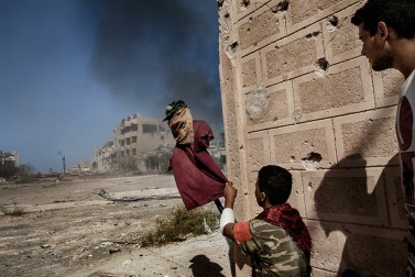 A fighter, supporter of the Libyan Government of National Accord, uses a dummy to catch the attention of Islamic State snipers at the frontline in Sirte on September 22, 2016.