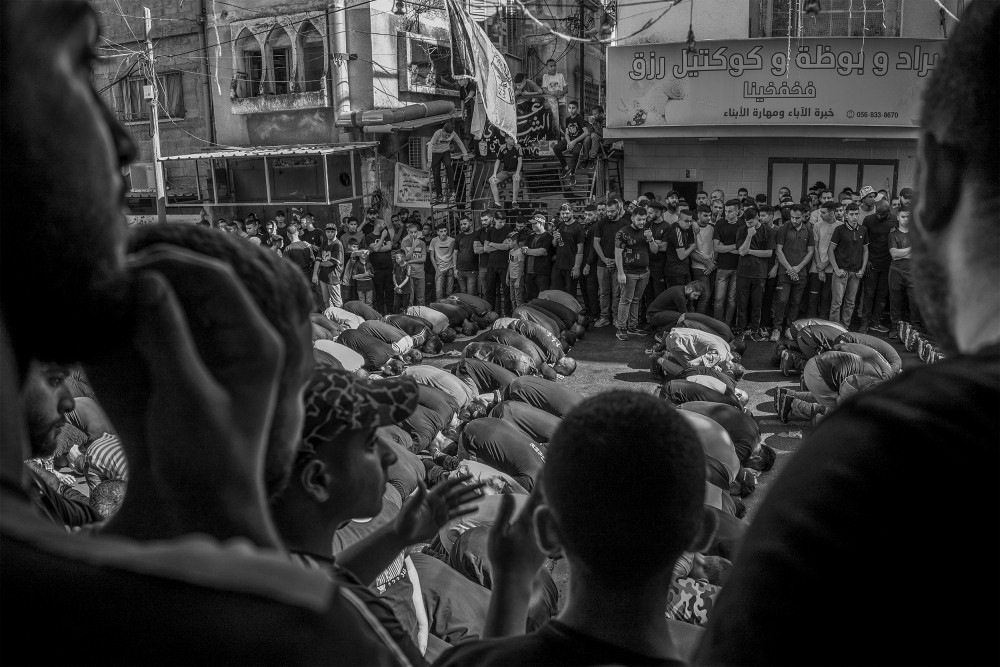 Muslims pray in front of the mosque in the Tulkarem refugee camp during the funeral of four men killed in the nighttime raid by the IDF on November 7, 2023. Three of the individuals killed were militants, including Izz A-Din Awad, a Hamas commander.