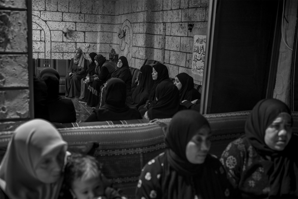 Women, relatives, and friends gather in a house in the Tulkarem refugee camp during the three-day funeral vigil for the death of Izz A-Din Awad, a Hamas commander. He was killed, along with three others, during the funeral of four men in the nighttime raid by the IDF on November 7, 2023.
